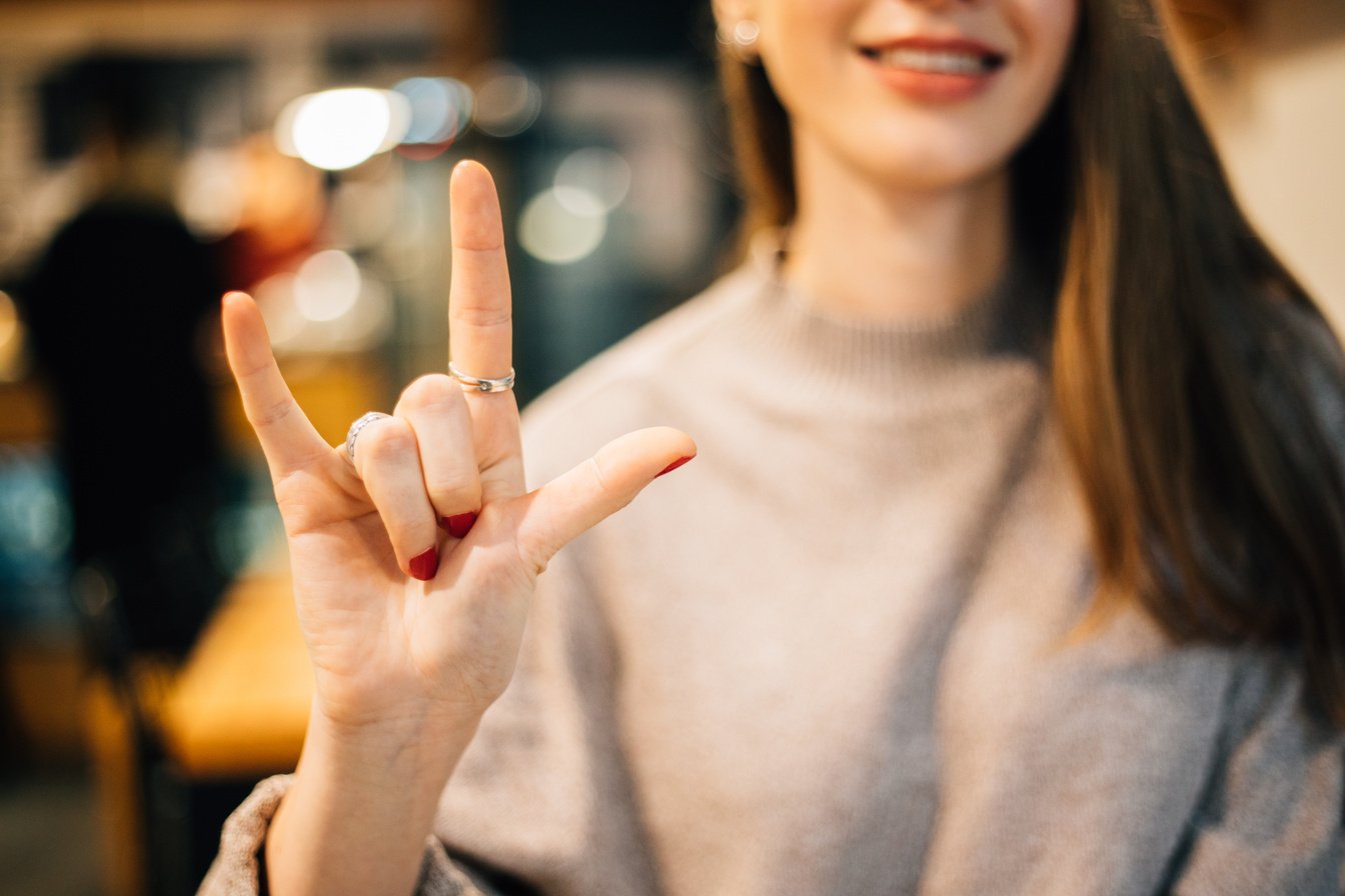 Beautiful woman saying I Love You in sign language